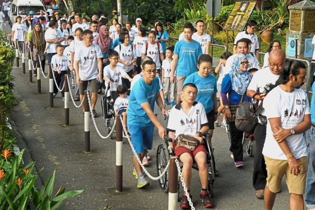 Participants of charity walk for the disabled make new friends and share their experiences