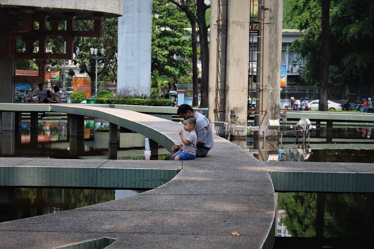 An Asian man and a young child