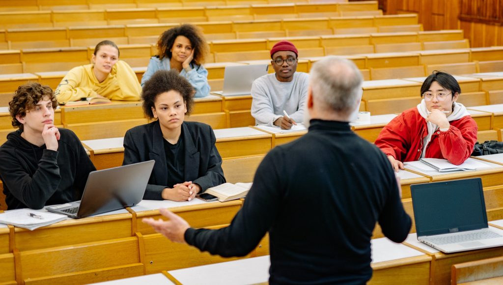 A lecturer speaks to a diverse group of students